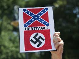 A sign comparing the Confederate flag to the Nazi flag. Symbols of heritage or of racial hatred?