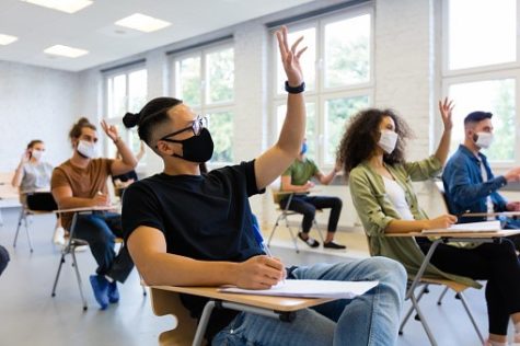 Students wearing masks while inside a classroom