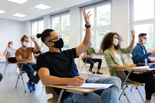 Students wearing masks while inside a classroom